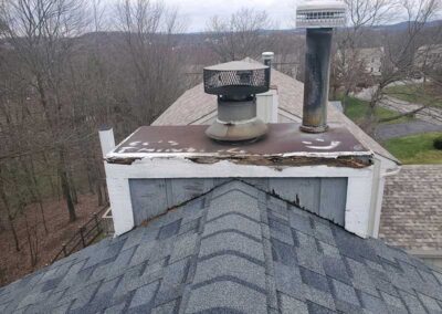 Chase Cover Replacement Before - Two caps with woods in the wintertime in the background and a few houses