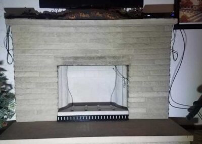 Ahren-Fire Firebox after installation TV on mantle picture to the right Christmas tree to the left with tarp still covering the flooring.