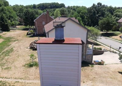 Chase Cover before replacement with homes and trees in the background