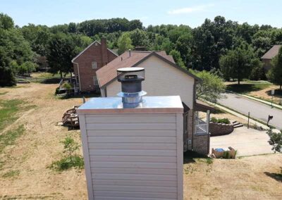 Chase Cover stainless steel after replacement - homes and trees in the background