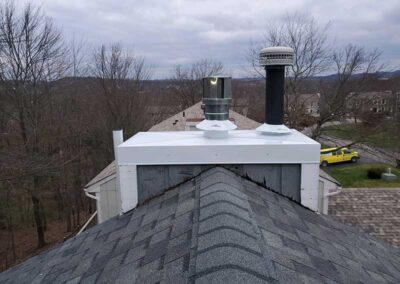 Chase Cover Replacement After - wintertime trees in the background with a few houses and a yellow van.