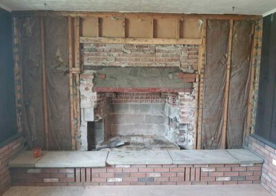 Ahren-Fire Firebox before replacement with exposed studs and insulation.