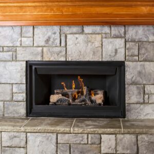a gas fireplace insert in a gray stone fireplace with a wood mantel