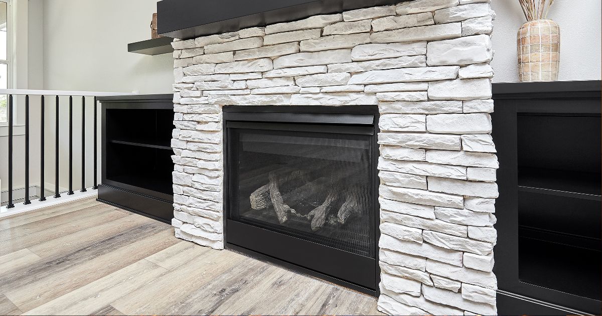 gas fireplace with a white brick fireplace facing