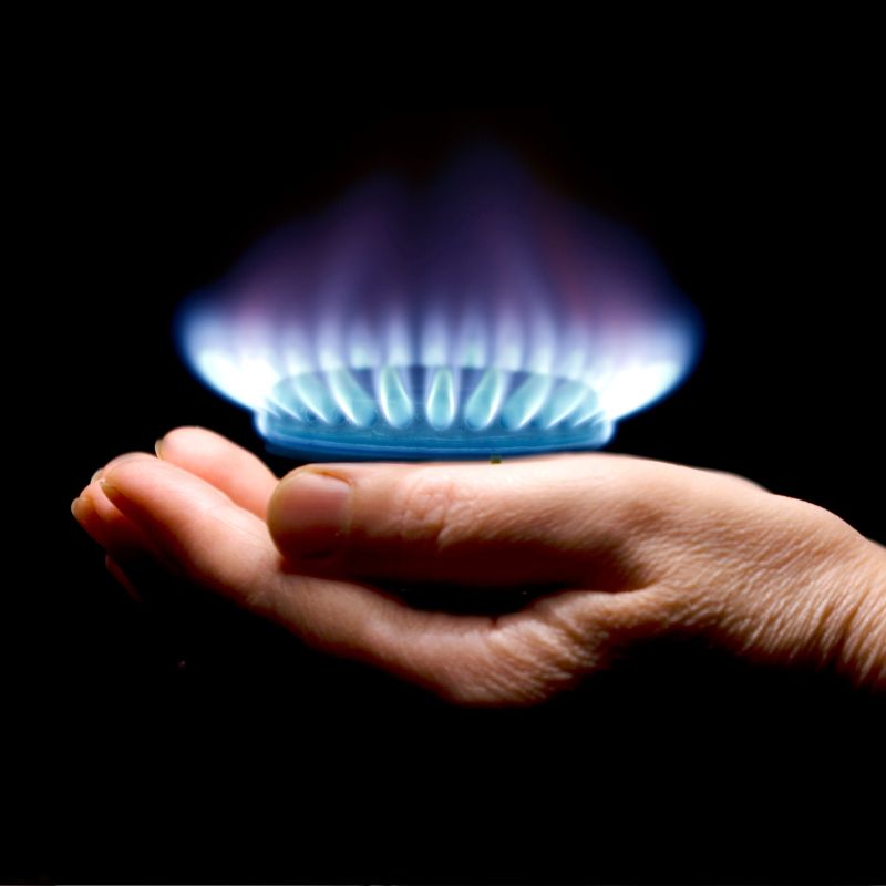 gas flames hovering over a person's hand